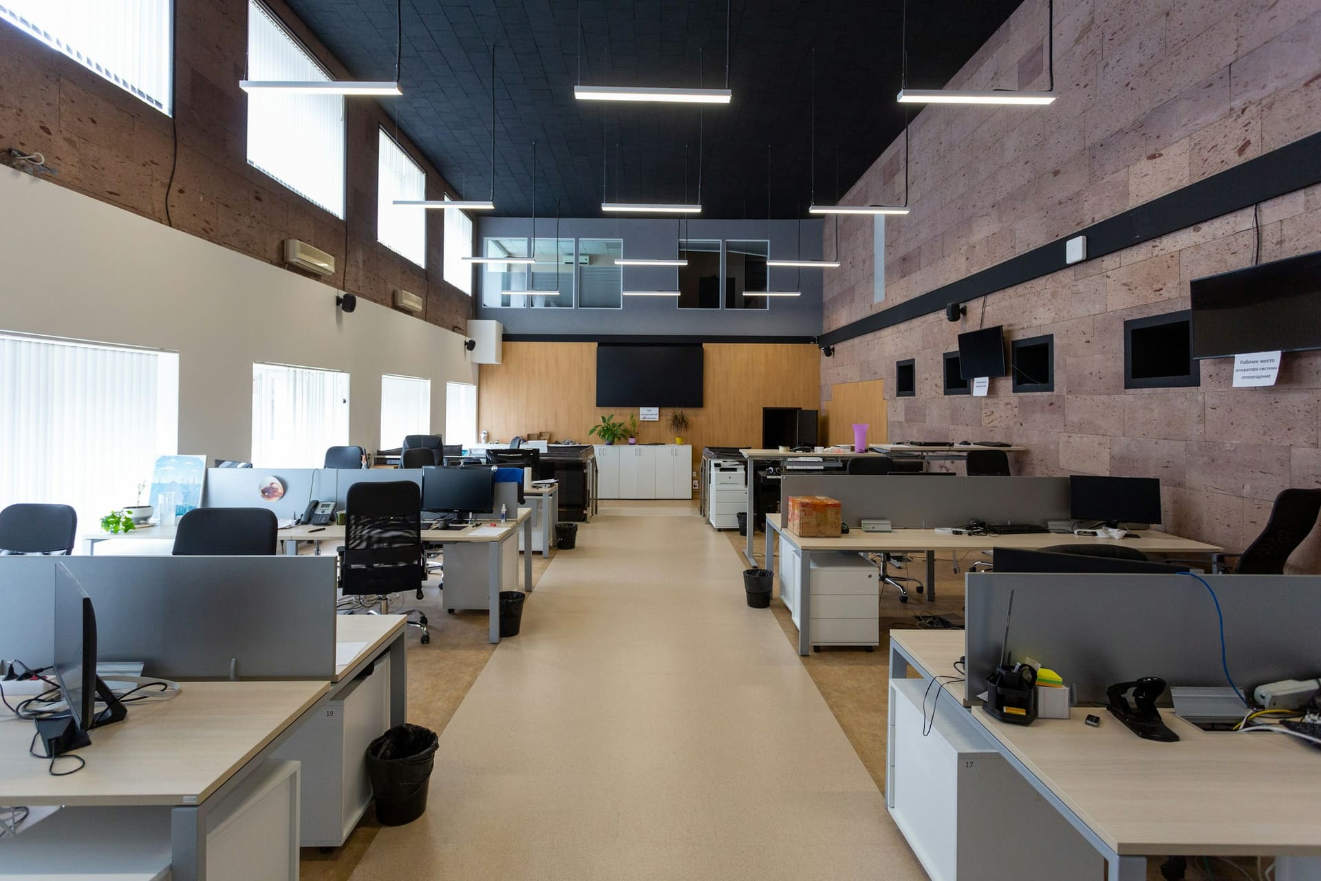 Business technology context: an open-plan office with multiple equipped desks.
