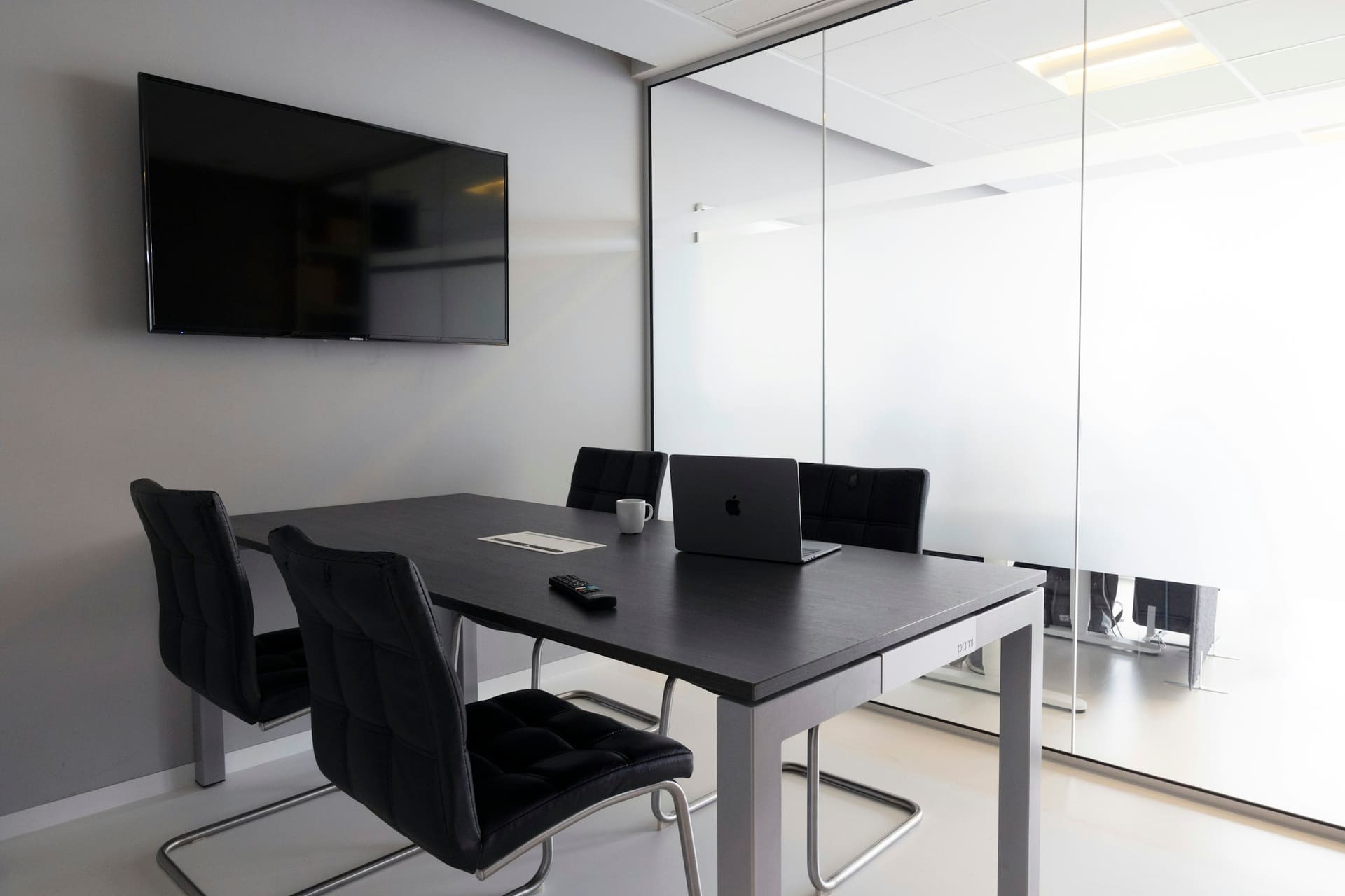 Collaboration environment: a meeting room with a wall-mounted display.