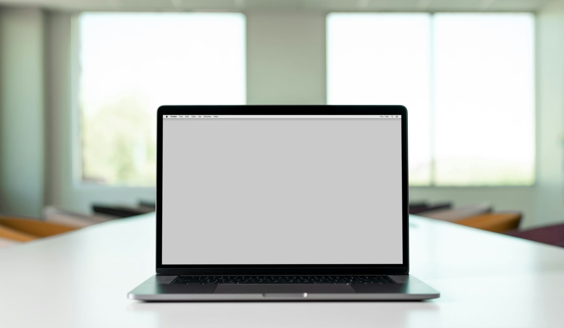 Professional workstation context: a laptop workspace set up for focused work.