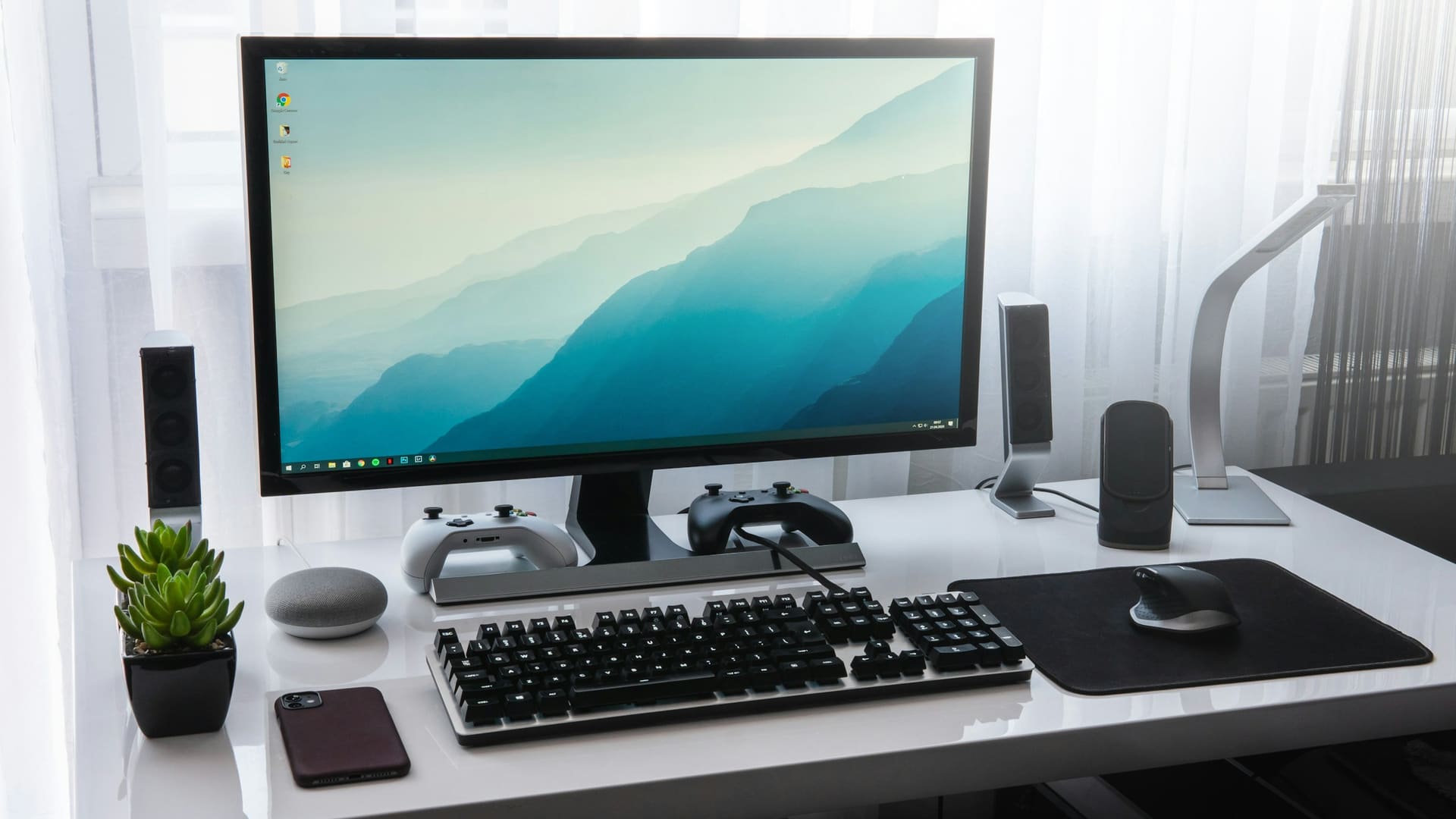 Professional workstation context: desk monitors arranged for multi-screen working.