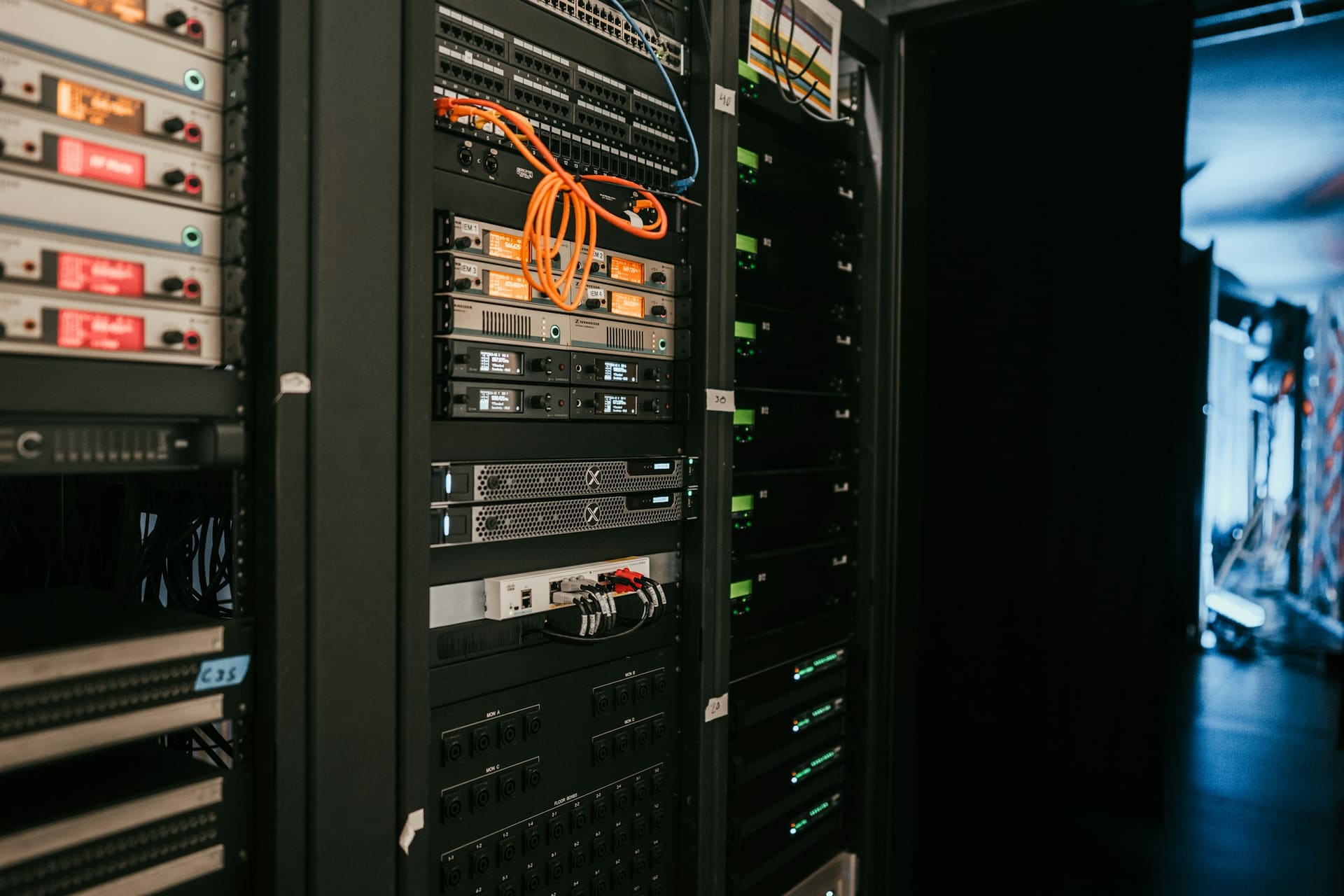 Networking equipment context: a patch panel and structured cabling in a network cabinet.