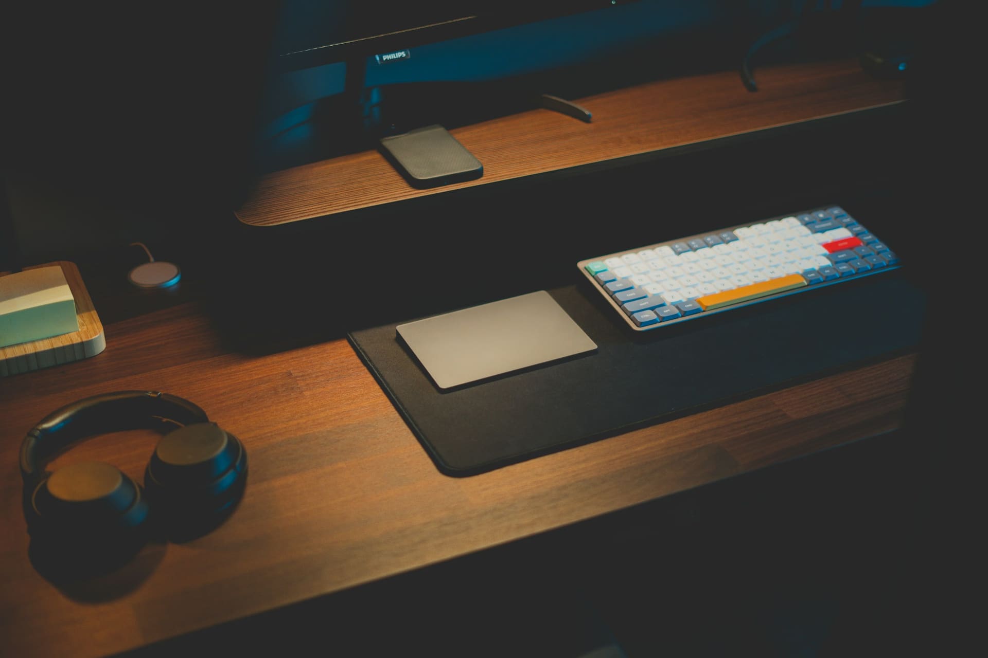 Business technology context: a headset beside a computer on a desk.